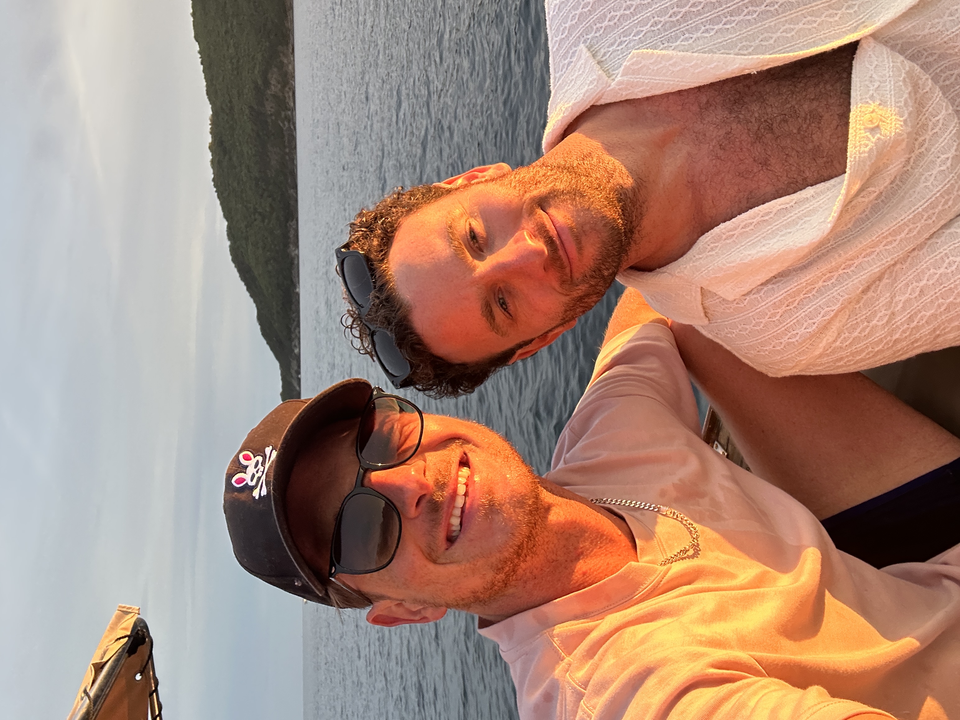 Casa founders Alex Rios and Jake Levinson on a boat at sunset